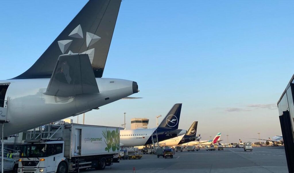 Budget airfare for family travel with several airplanes parked at an airport.