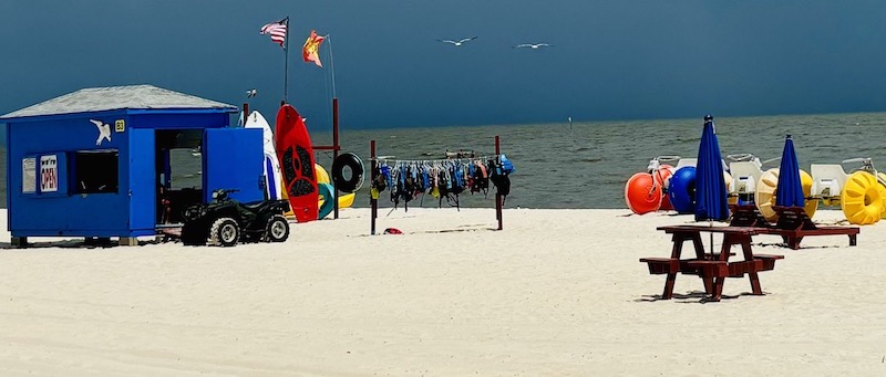 Biloxi beach rental stand with kayaks and paddle boats.