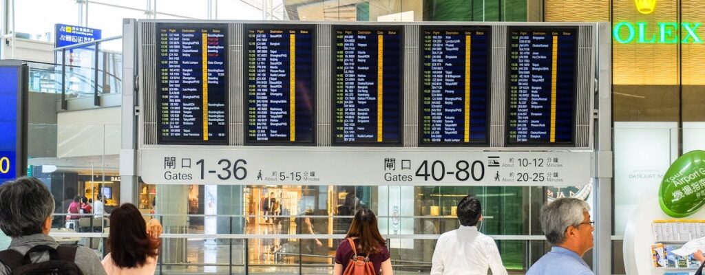 Flight information board displaying departure times at an international airport