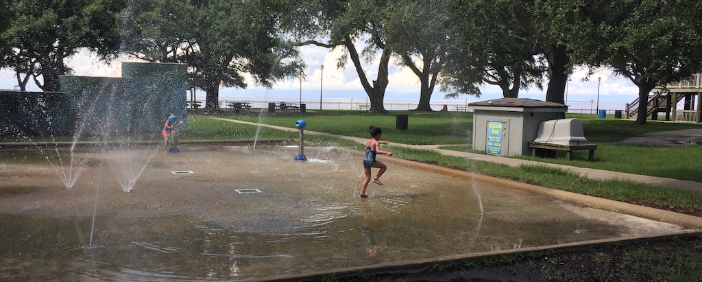 Children playing in a splash pad near Pascagoula Pier.