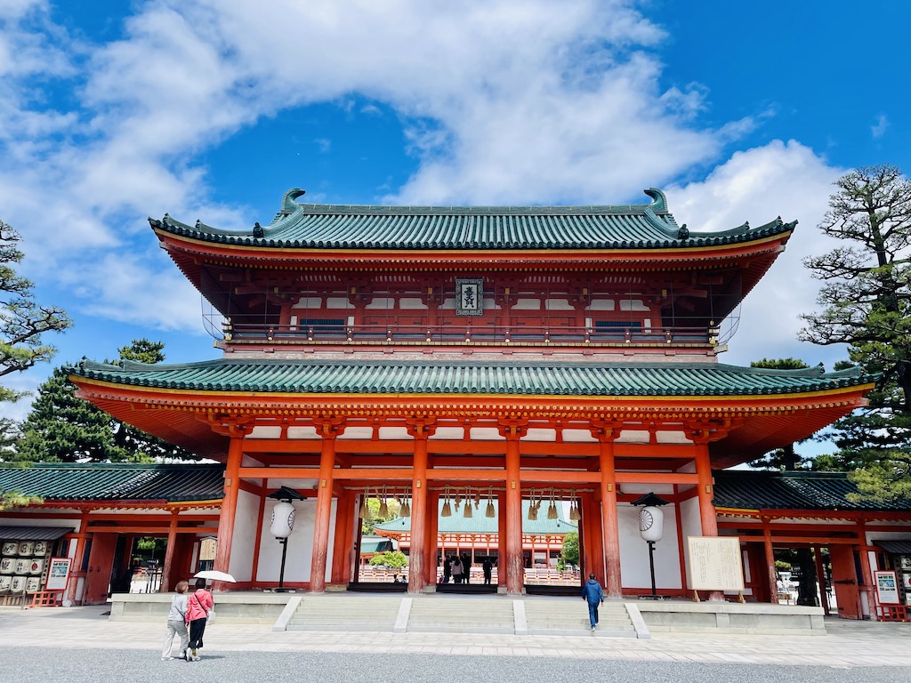 Heian Shrine gate in Kyoto, Japan, with blue sky backdrop.