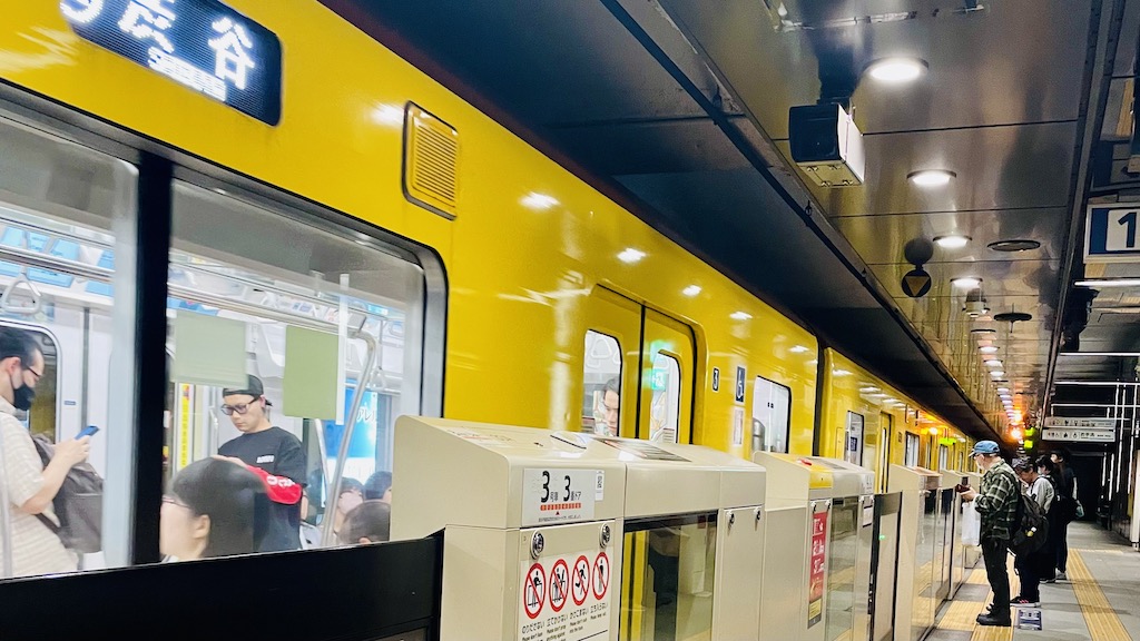 Yellow train at a subway station in Tokyo.