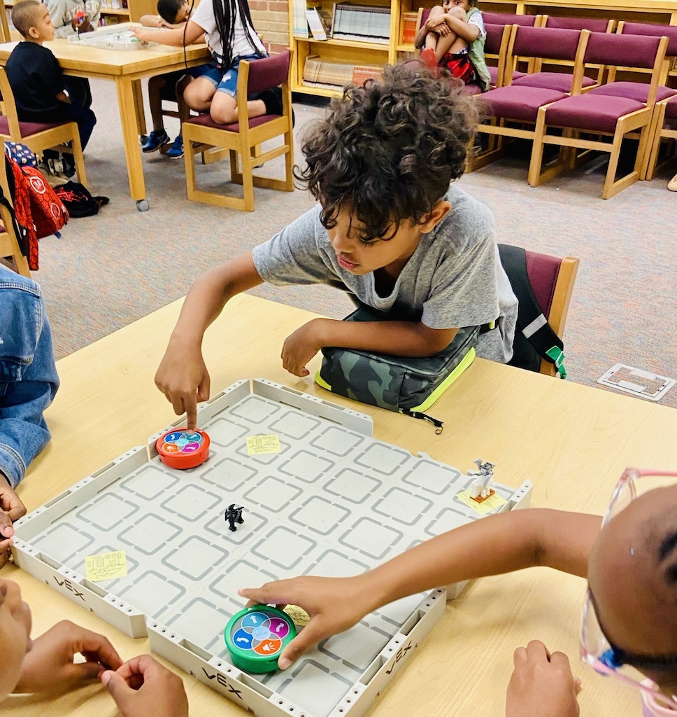 Children participating in a robotics club at an elementary school