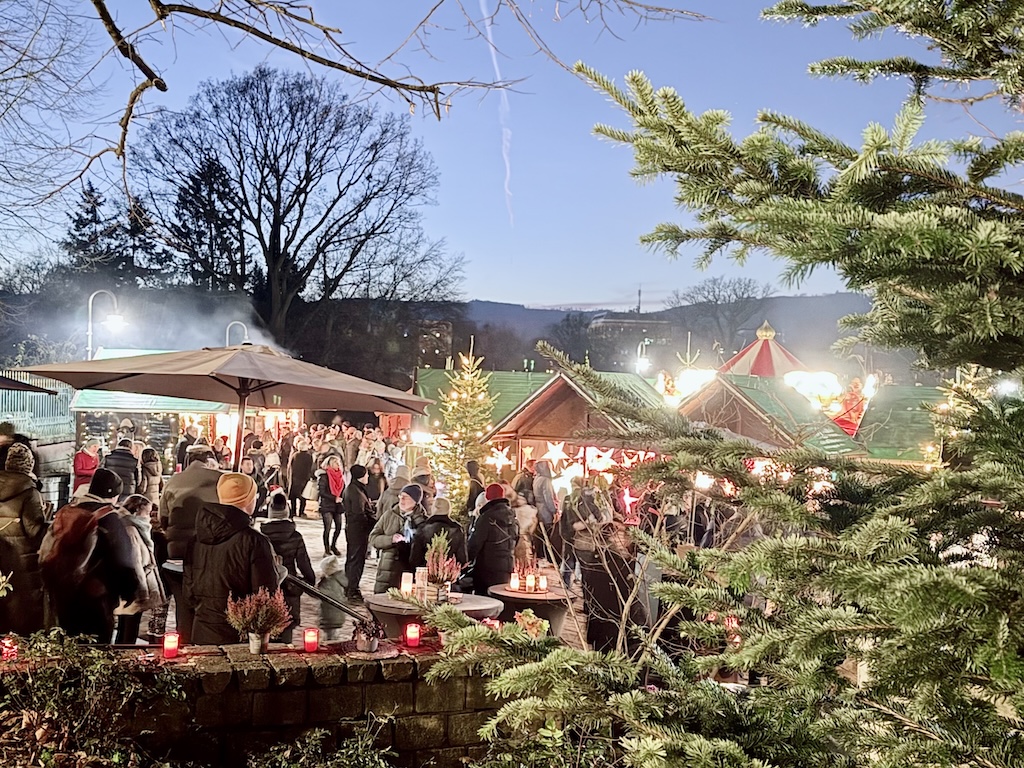 Christmas market in Bad Homburg, featuring festive stalls, sparkling lights, and a vibrant holiday crowd.