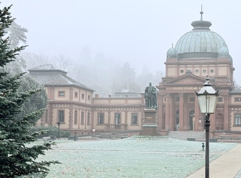 Kaiser Wilhelms Bad in Bad Homburg, surrounded by mist and frost, a historic spa building ideal for day trips from Frankfurt.